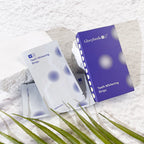 GlorySmile teeth whitening strips packaging on a textured white surface with green leaves.