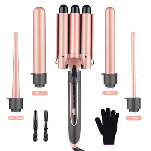 Rose gold hair curling iron set with interchangeable barrels and a black glove on a white background