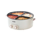 Multi-sectioned electric pot with food on a white background