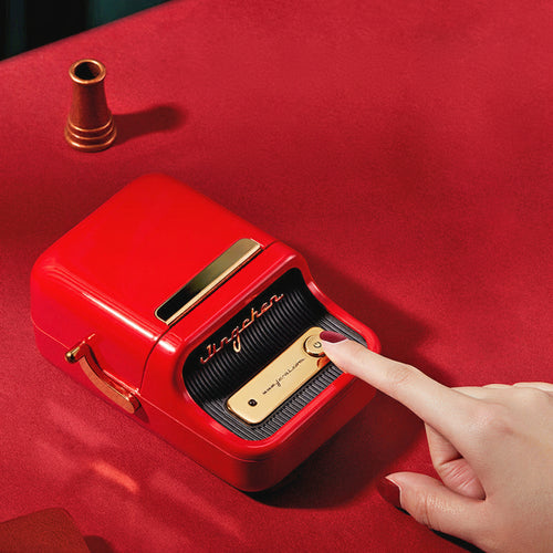 Red label printer with a hand pressing a button on a red background