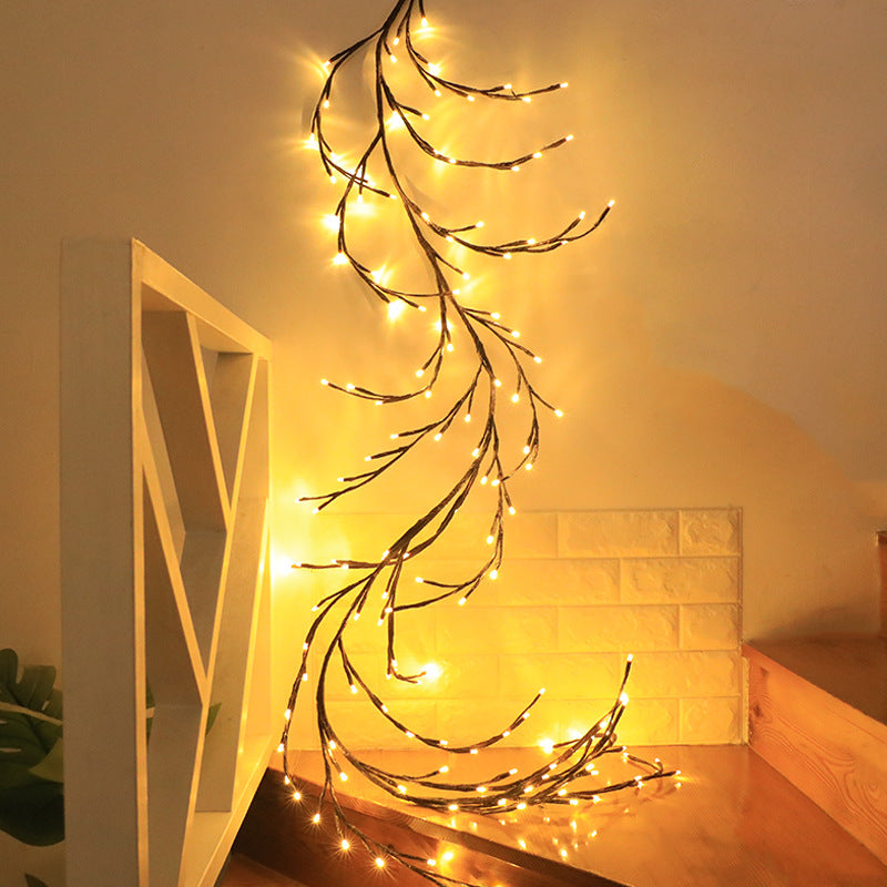 Decorative Willow string lights on a against a wall with a white shelf.